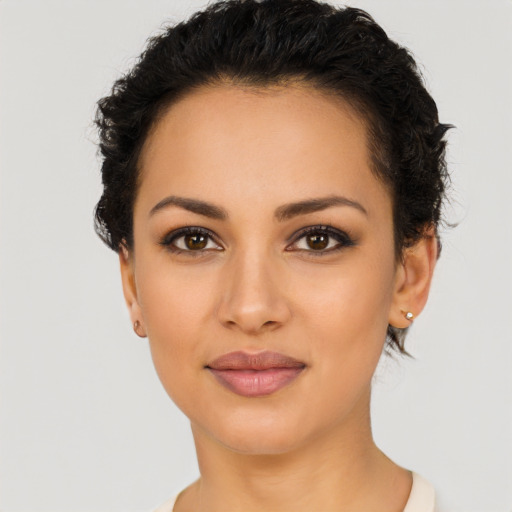 Joyful latino young-adult female with short  black hair and brown eyes