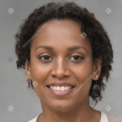 Joyful black young-adult female with short  brown hair and brown eyes