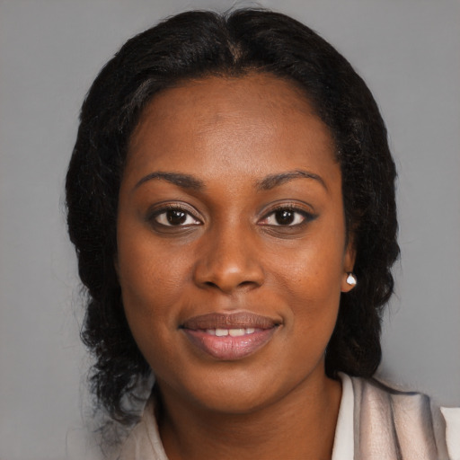 Joyful black young-adult female with medium  brown hair and brown eyes