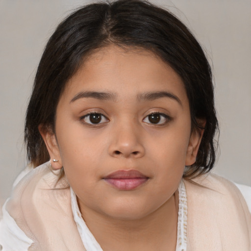 Joyful latino child female with medium  brown hair and brown eyes