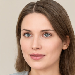 Joyful white young-adult female with long  brown hair and green eyes