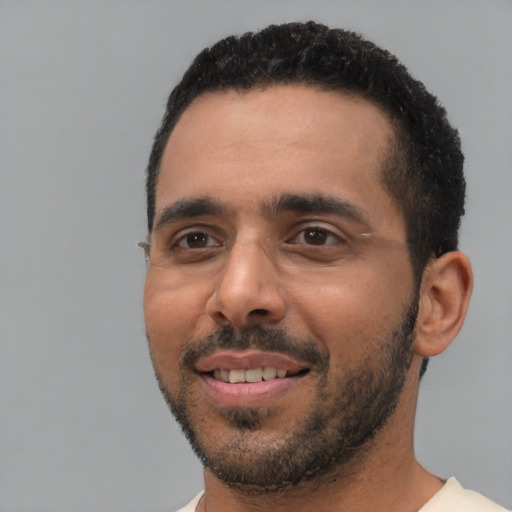 Joyful white young-adult male with short  black hair and brown eyes