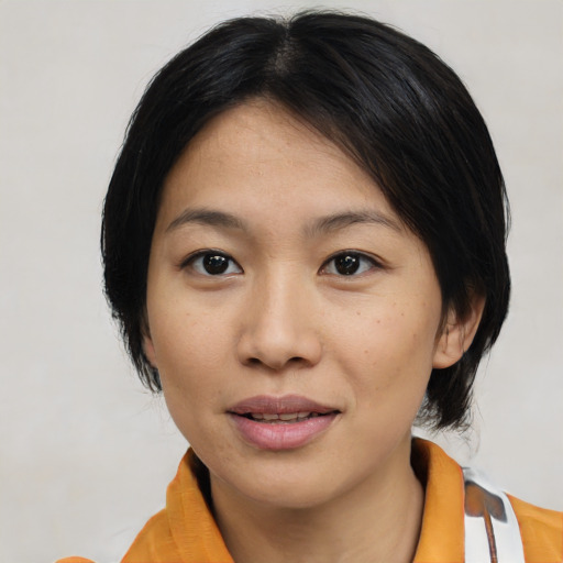 Joyful asian young-adult female with medium  black hair and brown eyes