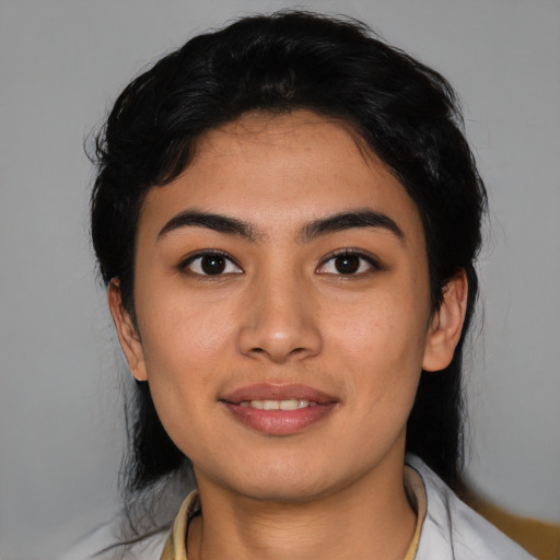 Joyful latino young-adult female with medium  black hair and brown eyes
