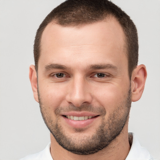 Joyful white young-adult male with short  brown hair and brown eyes