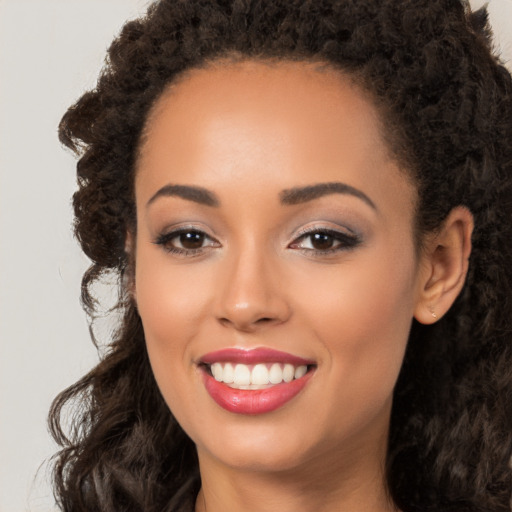 Joyful latino young-adult female with long  brown hair and brown eyes