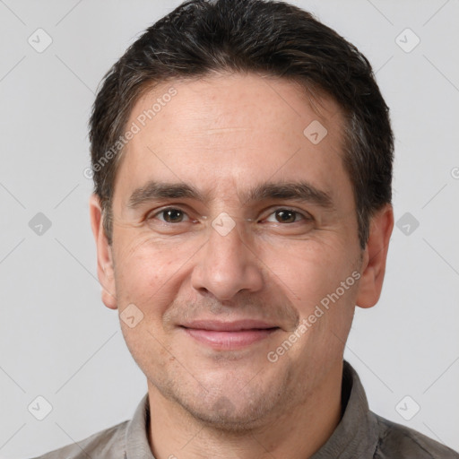 Joyful white adult male with short  brown hair and brown eyes