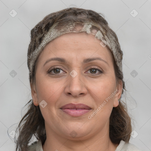 Joyful white adult female with medium  brown hair and brown eyes