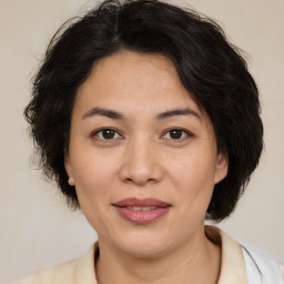 Joyful latino adult female with medium  brown hair and brown eyes