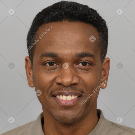 Joyful black young-adult male with short  black hair and brown eyes