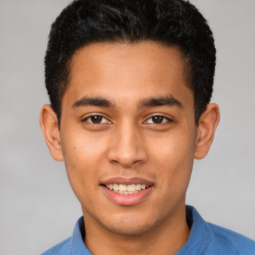 Joyful latino young-adult male with short  brown hair and brown eyes