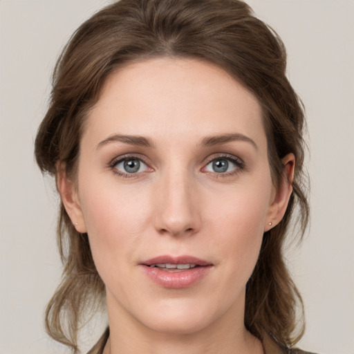 Joyful white young-adult female with medium  brown hair and grey eyes