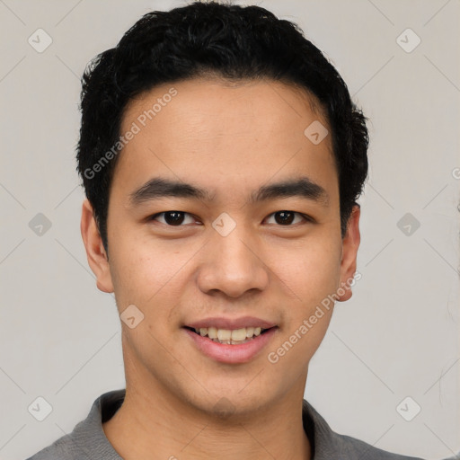 Joyful latino young-adult male with short  black hair and brown eyes