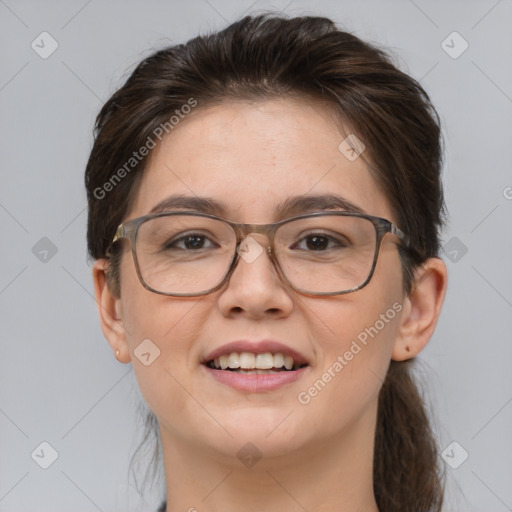 Joyful white adult female with medium  brown hair and brown eyes