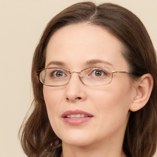 Joyful white adult female with long  brown hair and blue eyes