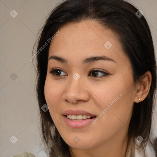 Joyful asian young-adult female with long  brown hair and brown eyes