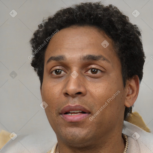 Joyful black adult male with short  brown hair and brown eyes