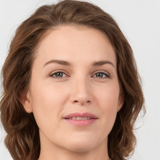 Joyful white young-adult female with long  brown hair and green eyes