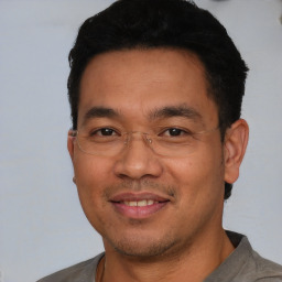 Joyful white adult male with short  black hair and brown eyes