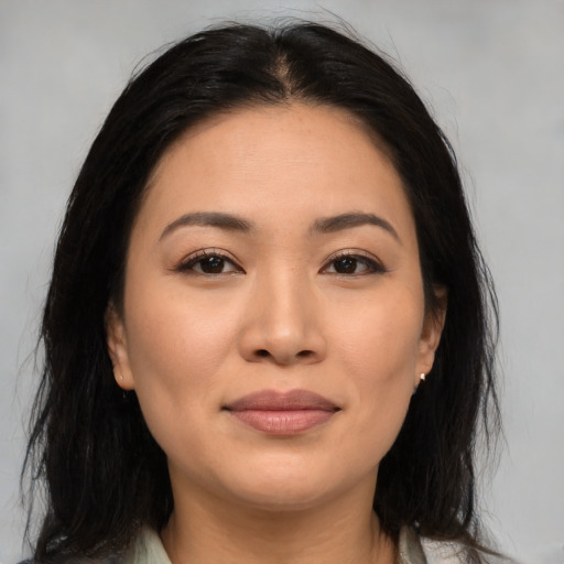 Joyful asian young-adult female with medium  brown hair and brown eyes
