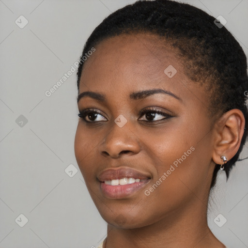 Joyful black young-adult female with short  black hair and brown eyes