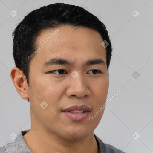 Joyful asian young-adult male with short  black hair and brown eyes