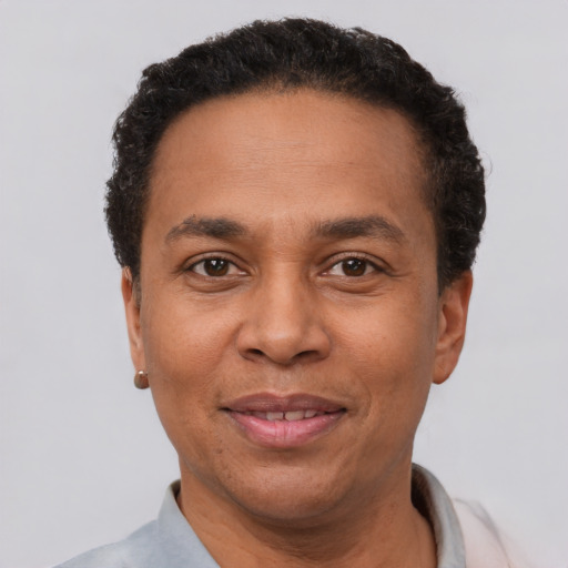 Joyful latino adult male with short  black hair and brown eyes