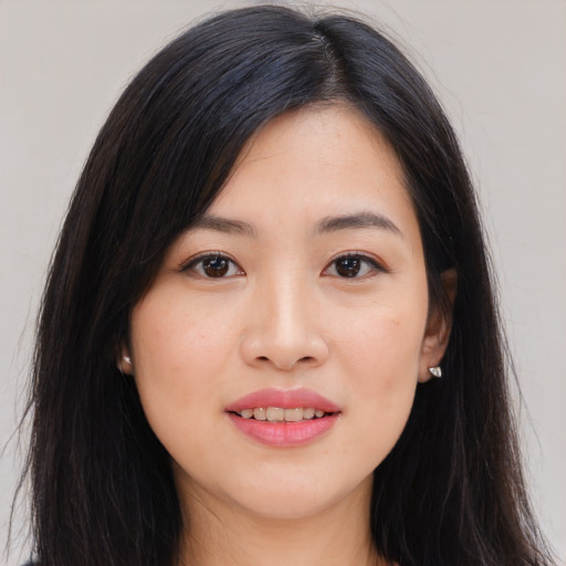 Joyful asian young-adult female with long  brown hair and brown eyes