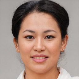 Joyful asian young-adult female with medium  brown hair and brown eyes