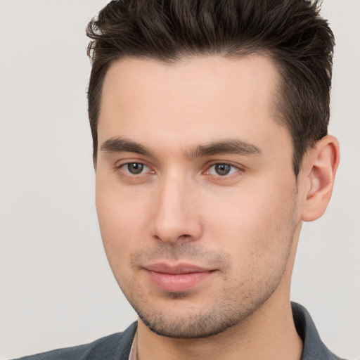 Joyful white young-adult male with short  brown hair and brown eyes