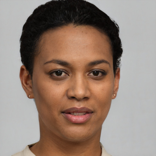 Joyful black young-adult female with short  black hair and brown eyes