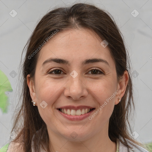 Joyful white adult female with medium  brown hair and brown eyes