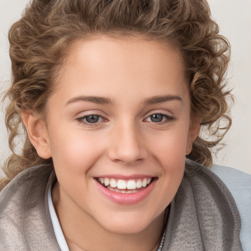 Joyful white child female with long  brown hair and brown eyes