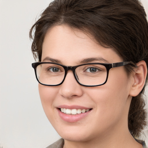 Joyful white young-adult female with medium  brown hair and blue eyes