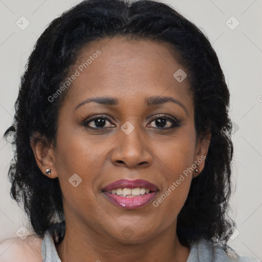 Joyful black adult female with long  brown hair and brown eyes