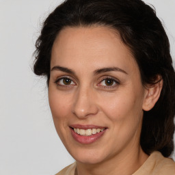 Joyful white adult female with medium  brown hair and brown eyes