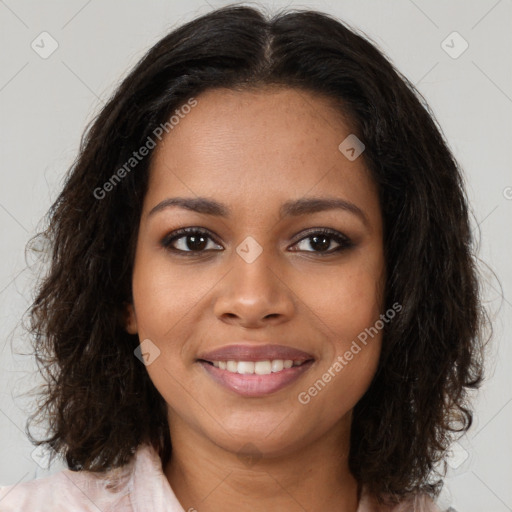 Joyful black young-adult female with medium  brown hair and brown eyes