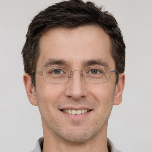 Joyful white adult male with short  brown hair and brown eyes