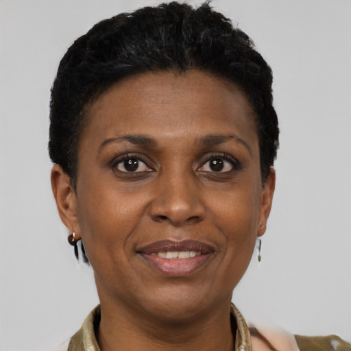 Joyful black adult female with short  black hair and brown eyes