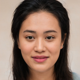 Joyful asian young-adult female with long  brown hair and brown eyes