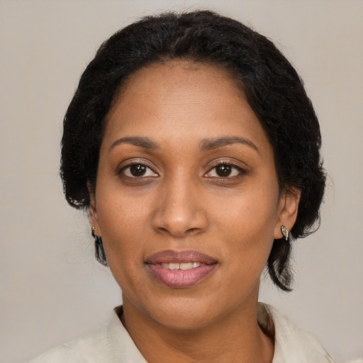 Joyful black adult female with medium  black hair and brown eyes