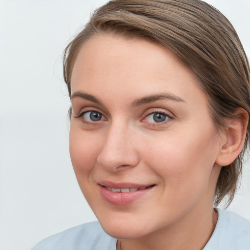 Joyful white young-adult female with medium  brown hair and blue eyes