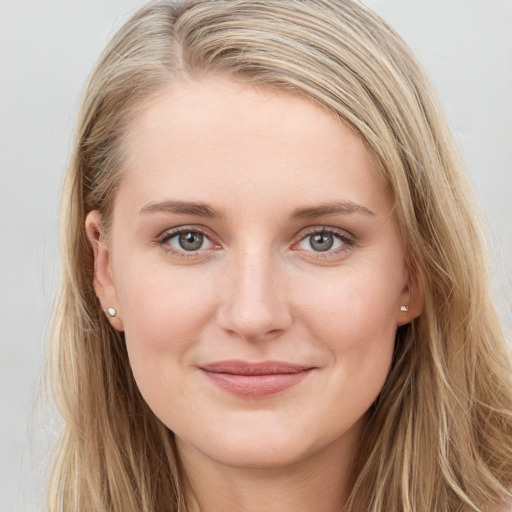 Joyful white young-adult female with long  brown hair and blue eyes