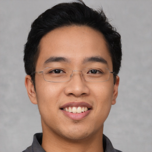Joyful asian young-adult male with short  black hair and brown eyes