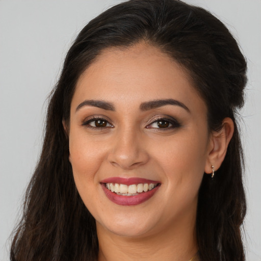 Joyful white young-adult female with long  brown hair and brown eyes