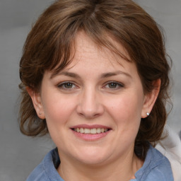 Joyful white adult female with medium  brown hair and grey eyes