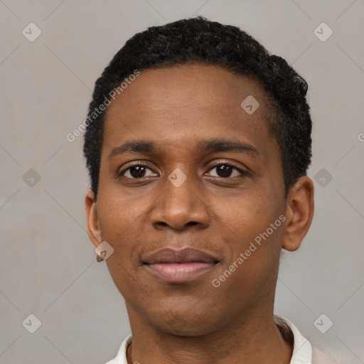 Joyful black young-adult male with short  black hair and brown eyes