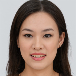 Joyful asian young-adult female with long  brown hair and brown eyes