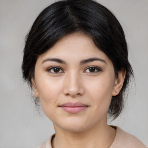 Joyful asian young-adult female with medium  brown hair and brown eyes