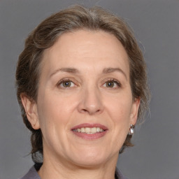 Joyful white adult female with medium  brown hair and grey eyes